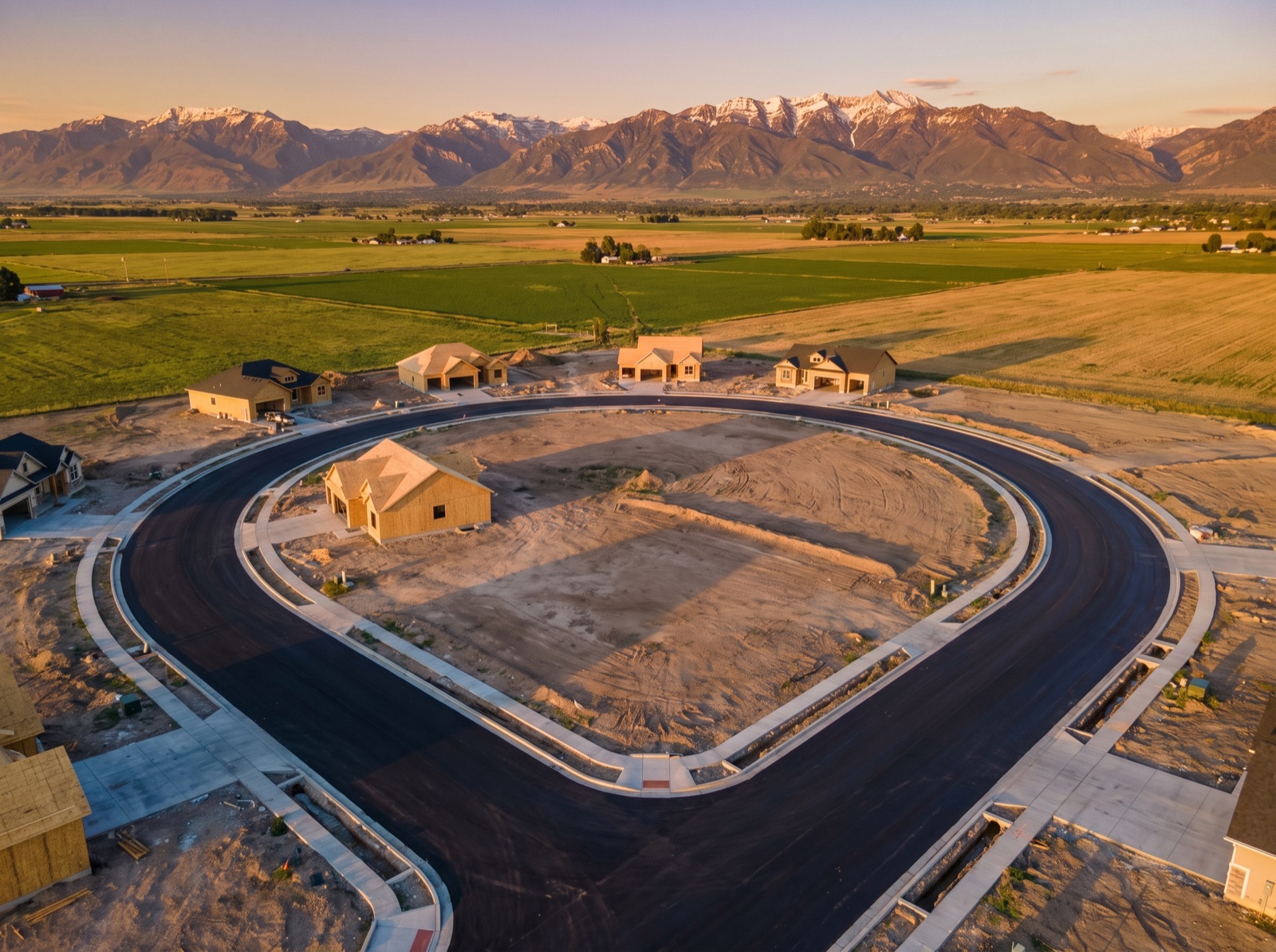 Aerial view of a new subdivision with fresh streets and graded lots